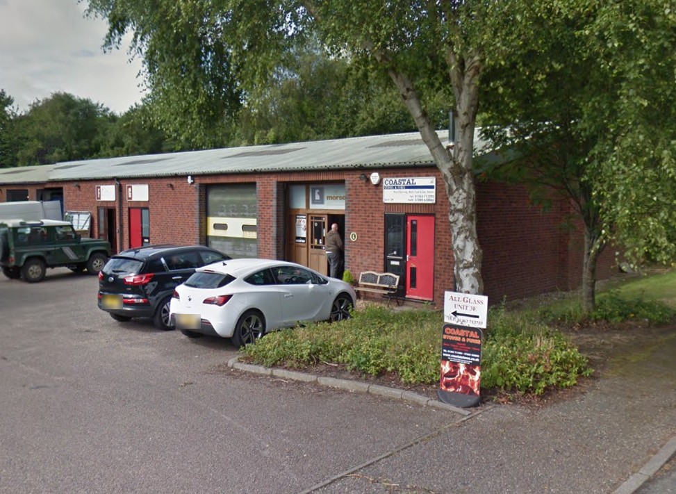 The Coastal Stoves & Fires unit on Glaven Road, Holt, with its fascia sign, a Morsø panel in the window and an A-board outside
